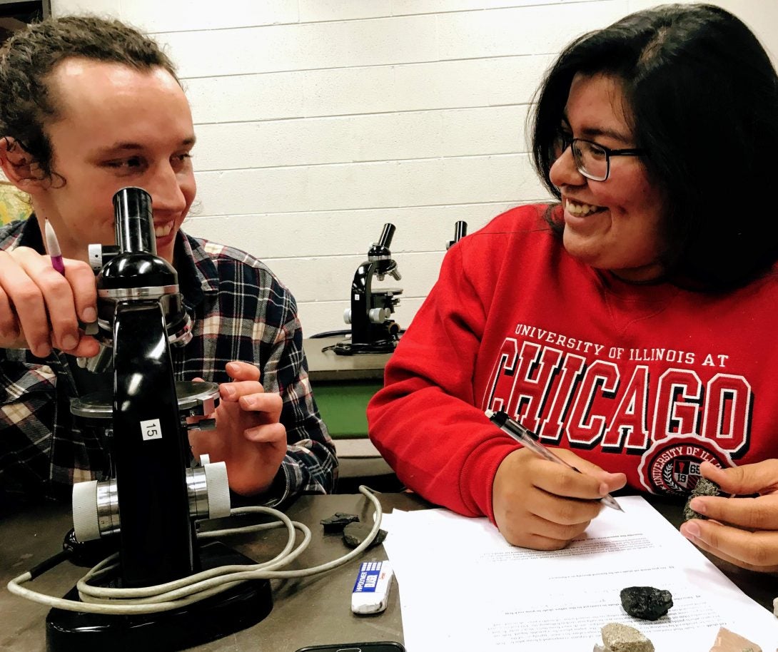 Geoscience students in class with microscopes